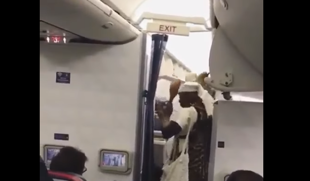 Watch Ooni of Ife performs cleansing rites on plane to Canada