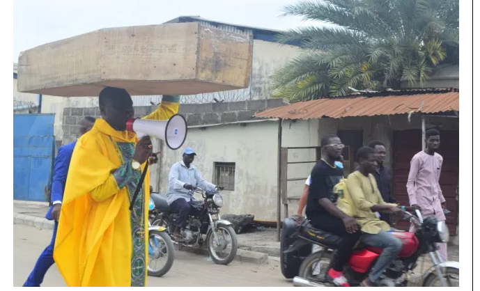 Amazing! Pastor carries coffin in Amuwo-Odofin, says God is Angry