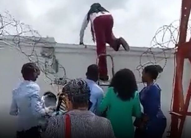Camera captures bank workers scale fence to evade aggrieved customers
