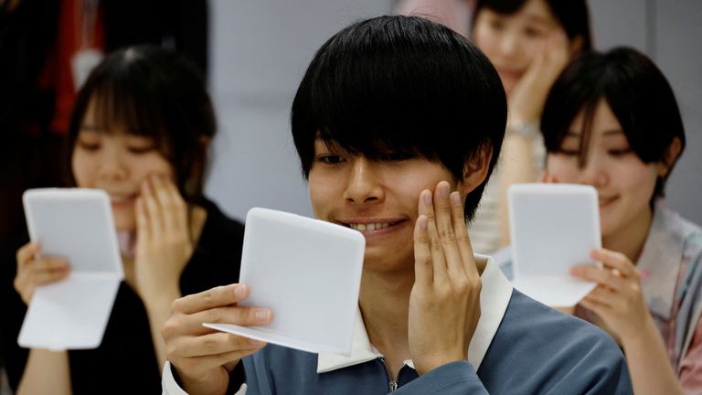 COVID-19: People in Japan who got used to face masks are attending smiling lessons