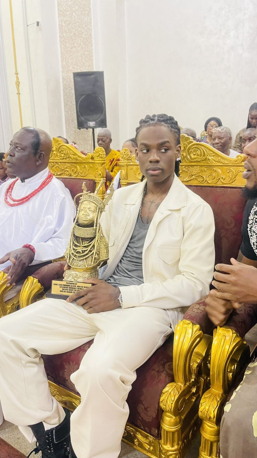 Reactions trail man besides Oba Of Benin’s gift to Rema